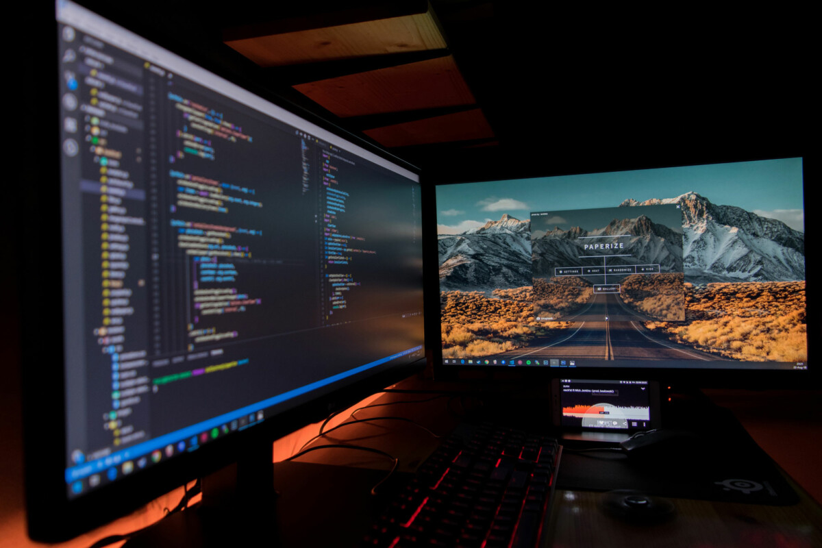 Computer scene at night with website development code on screen